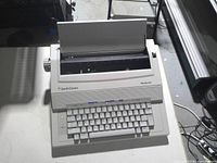 Front angled view showing keyboard, carriage and branding