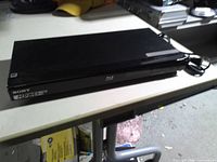 Front angled view of Sony BDP-S470 showing top and attached power cord