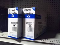 Front view of both Superior NHCE505XU-ND toner cartridge boxes on shelf