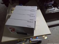 Four sealed toner cartridge boxes on table