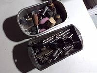 Overhead view of two trays containing mixed drill and rotary tool bits, stones, polishing tips and trays