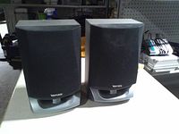 Front view of both Venturer speakers showing grilles and bases