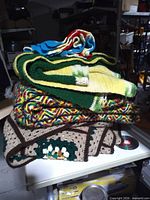 Stack of four vintage crochet afghans on shelf