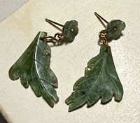 Front view of both earrings showing carved jade leaves and flower studs