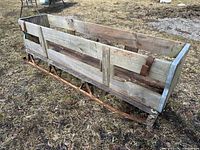 Full view of wooden box sled on iron runners
