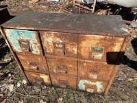 Front view showing nine-drawer layout, rust, paint remnants