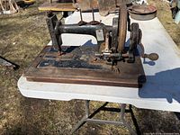 Left side view of entire sewing machine on wooden base
