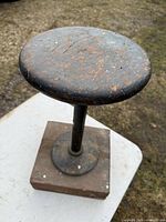 Overall view of stool showing seat, pedestal and base