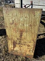 Front view showing rusted exterior and faint Champion graphics