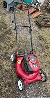 Full view of red Craftsman mower showing deck, handle and wheels