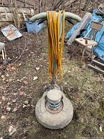 Full view of floor buffer standing upright with cord draped over handle