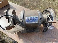 Bench grinder front view showing wheels and rests