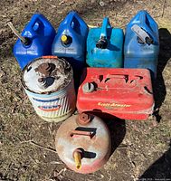 Seven cans grouped; shows variety and condition