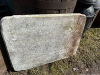 Front view of marble slab leaning against barrel