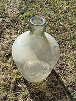Full view of clear glass jug standing upright