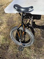 Full view of Mongoose unicycle leaning against table