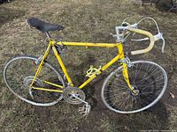Full side view of yellow Schwinn road bicycle outdoors