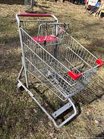 Side view of full metal shopping cart on grass