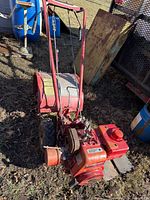 Full view of Troy-Bilt tiller showing engine, tines, handlebars