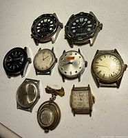 Group shot of all nine watch heads displaying fronts and relative sizes