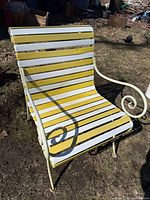 Front angled view showing yellow and white slats and scroll arm