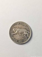 Reverse showing striding bobcat design and 25 cents legend