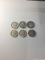 Six Roosevelt dimes arranged in two rows