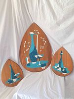 Front view of three plaques showing design and relative sizes