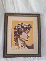 Full view of framed needlepoint artwork