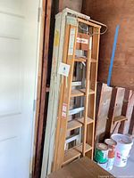 Wood and aluminum step ladders standing together