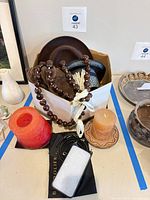 Entire lot showing hat box with hats, candles, phone case, necklace, vase