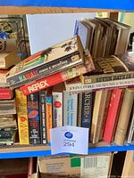 Shelf with Hawaii, Reflex, Silent Witness and other paperbacks