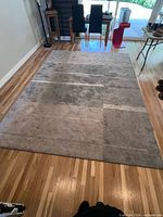 Rug laid flat full view on hardwood floor