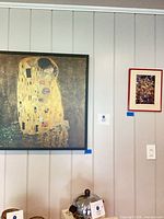 Both framed pieces on wall: Klimt print left, Shapiro photo right