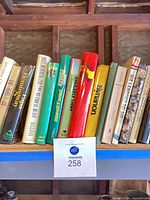 Left section of shelf showing Hemingway and several unidentified titles