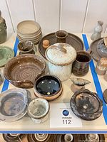 Overview of all Shapiro stoneware pieces within blue tape boundary