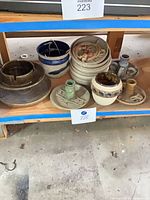 Shelf view showing entire pottery lot grouped together