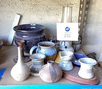 Overview of shelf showing majority of pottery pieces