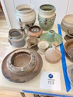 Group view of all Shapiro pottery pieces on table