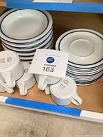 stack of cereal bowls and coffee cups showing blue rim design and Dansk mark
