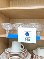 shelf view showing multiple swirl-etched champagne coupes