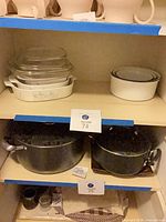 Shelf view showing Pyrex casserole stack and Dansk bowl set