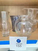 Group view of pitcher and vases on shelf