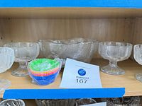 punch bowl centered with two glasses and stack of silicone liners