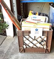 Crate with saw, drywall sanding sheet packs and lot label