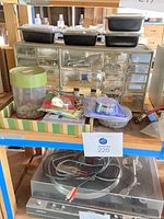 Overall view showing Sony turntable, parts cabinet, hardware containers and assorted fasteners