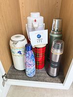 All six beverage containers inside cabinet