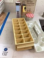 Overall lot showing ice trays, egg carrier, oil sprayers, preserve jar, Sunbeam attachment box