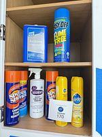 Full view of cabinet shelf showing all cleaning products