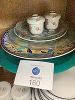 Stack showing two ceramic candle holders on plates and platters